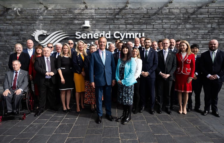 Nigel Farage on the steps of the Senedd in Cardiff with Helen Jenner the new Leader of Reform UK Wales, in fellow Senedd Members for Wales