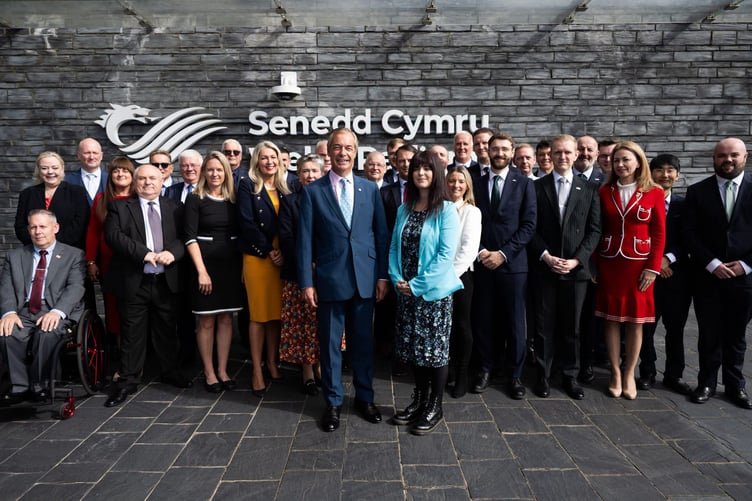 Nigel Farage on the steps of the Senedd in Cardiff with Helen Jenner the new Leader of Reform UK Wales, in fellow Senedd Members for Wales