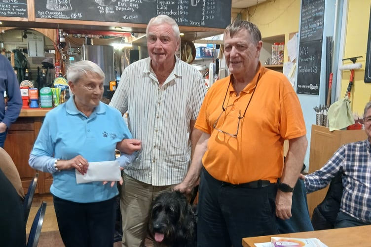 Pembrokeshire fundraiser Eva receives the donation on behalf of Guide Dogs Cymru