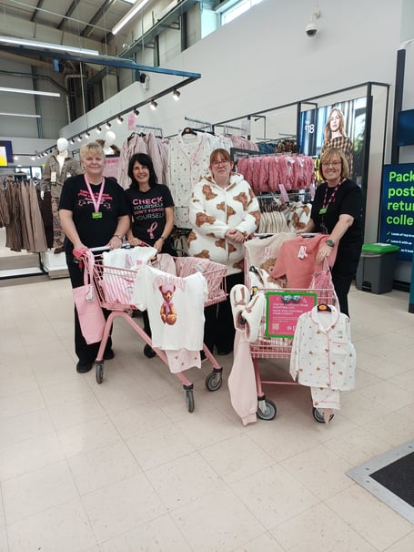 Colleagues at Asda Wrexham with the Tickled Pink Trolleys
