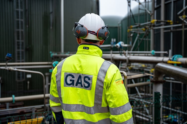 Man in helmet with GAS on high visibility jacket