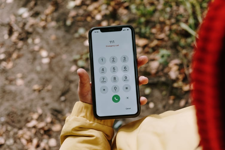 Smartphone on dialpad with 111 dialed