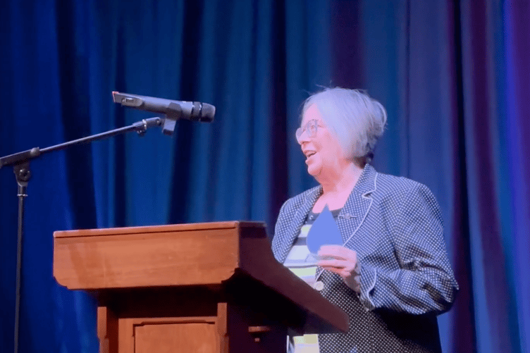 Ellen Powling on stage at the De Valence with her Good Neighbour award