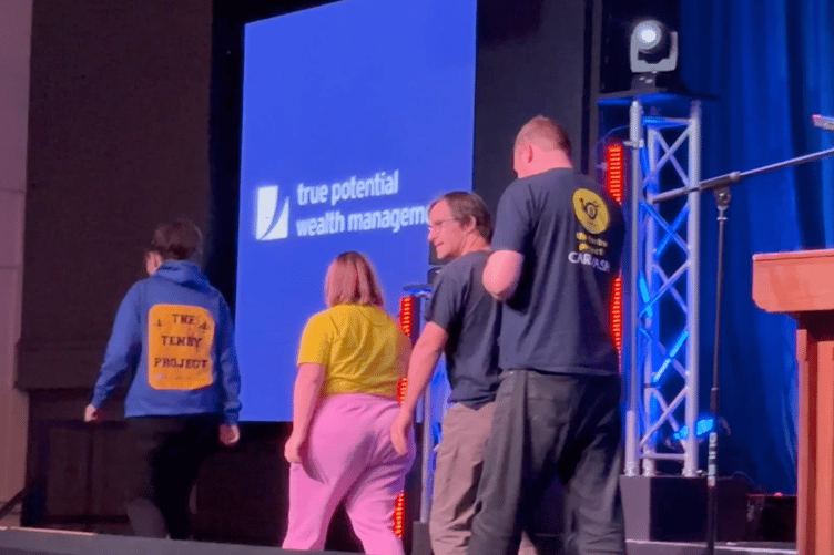 Four members of the Tenby Project leave the stage of the De Valence after receiving their Tenby Observer Community Kindness Award