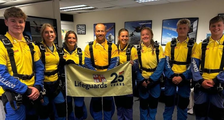 South Pembrokeshire lifeguards marked 25 years of keeping people safe on the coast with a team skydive over the Swansea coastline.