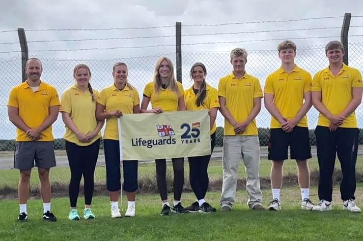 South Pembrokeshire lifeguards marked 25 years of keeping people safe on the coast with a team skydive over the Swansea coastline.