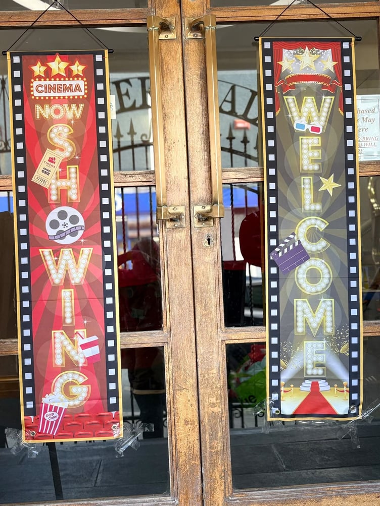 Cinema signs hanging on the doors of the Pater Hall, Pembroke Dock