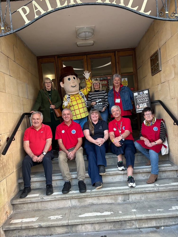 Group of councillors, trustees, outside Pater Hall with Toy Story costume character Woody for launch of Pater Picture House