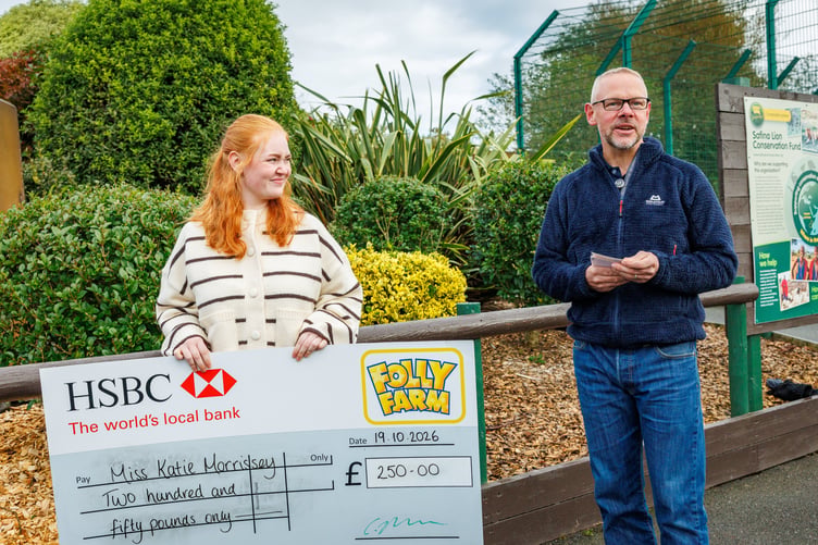 Winning art student Katie Morrisey receiving a cheque from Folly Farm’s managing director Chris Ebsworth