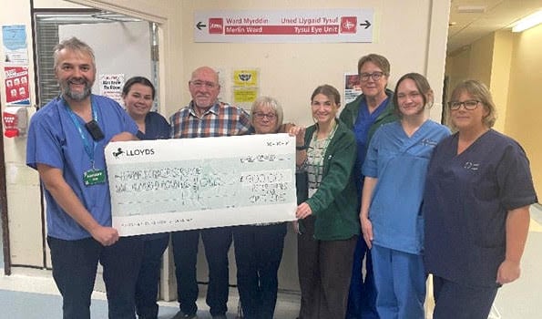 Peter and Janet James with staff from the Head and Neck Cancer Team and Merlin Ward at Glangwili Hospital.