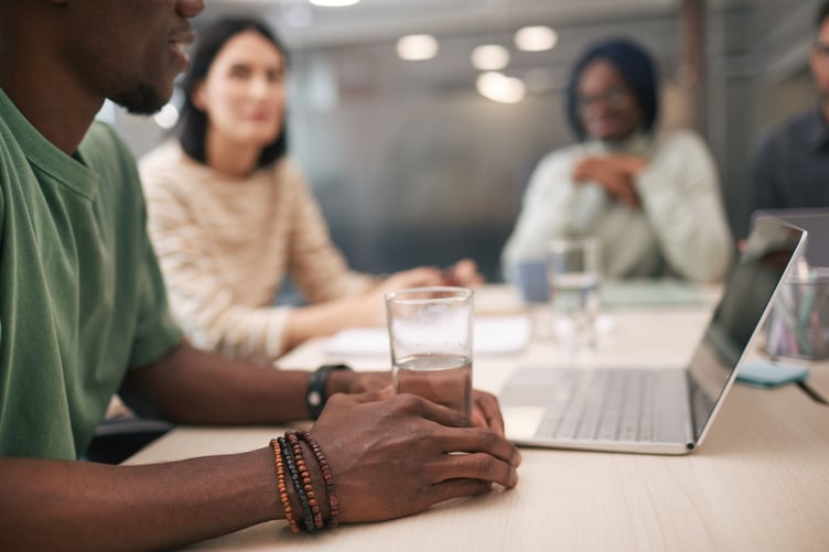 Mixed group of adults having serious conversation in office environment